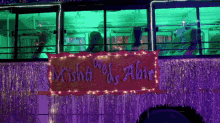 a bus is decorated with lights and a sign that says ' wishti we 's abir '