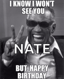 a man wearing sunglasses and a suit is making a peace sign