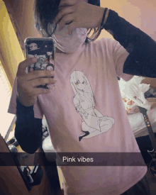 a person taking a selfie with a pink shirt that says pink vibes on it