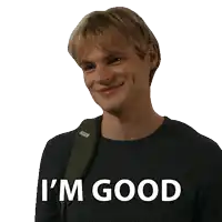 a man wearing a black sweater with the words i 'm good written on it