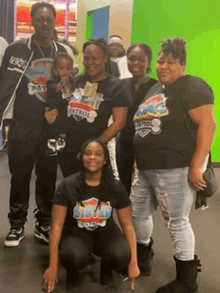 a group of people posing for a picture with one wearing a patrol shirt