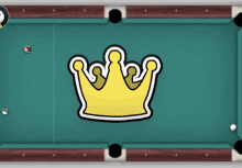 a pool table with a yellow crown on top of it