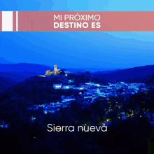 an advertisement for sierra nueva shows a village on a hillside at night