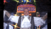 a man stands in front of a sign that says starcade
