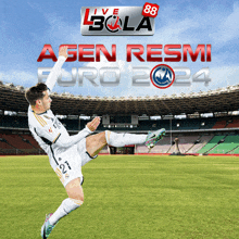 a soccer player kicking a ball in front of a sign that says agen resmi euro 24