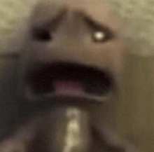 a close up of a person 's face with their mouth open and eyes closed .