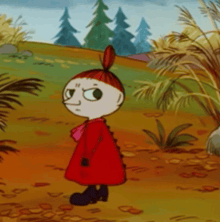 a little girl in a red dress stands in a field