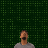 a man with a beard and glasses is looking up at the number 14