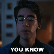 a young man wearing glasses says " what i meant "