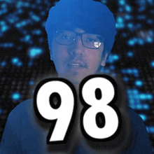 a man wearing glasses stands in front of a sign that says 98