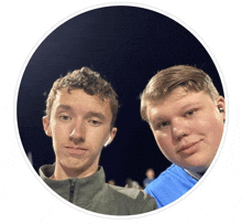 two boys are posing for a picture in a circle