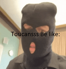 a person wearing a black ski mask with the words toucansss be like written below it