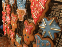 gingerbread cookies decorated with icing and sprinkles on a rack