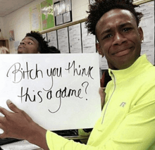 a man holding a sign that says bitch you think this is a game