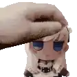 a person is petting a stuffed doll 's head .