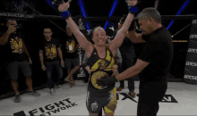 a woman in a boxing ring with a fight network logo on the floor