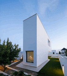 a very tall white building with a large window on the side