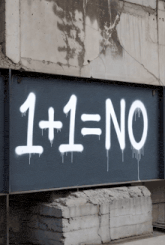 1 + 1 = no is spray painted on a black wall