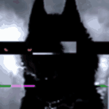 a silhouette of a wolf with red eyes is standing in the dark .