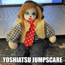 a clown doll is sitting in front of a laptop with the caption yoshiatsu jumpscare