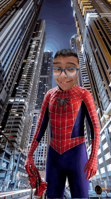 a boy in a spiderman costume is standing in front of a city skyline