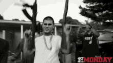 a black and white photo of a man holding a gun with the words " 1st monday " on the bottom