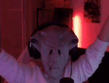 a person wearing a mask and headphones with their arms up