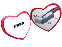 a heart shaped mirror with the name fred on the front