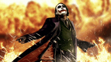 a joker is standing in front of a fire