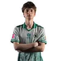 a young man wearing a green and white jersey with a logo on the front