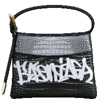 a black purse with the word balenciaga on it