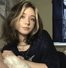 a girl sitting in front of a tarot tapestry that says x on it
