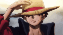 monkey d luffy from one piece is wearing a straw hat and a red ribbon .