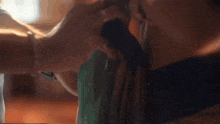 a close up of a person tying a tie with their hands