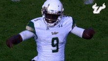 a football player wearing a white and green uniform with the number 5 on it