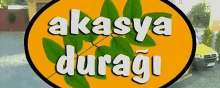 a yellow sign that says akasya duragi with leaves on it