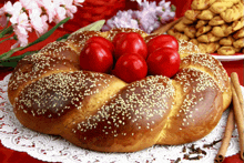 a loaf of bread with sesame seeds and red eggs in the middle