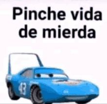 a picture of a blue car with the words `` pinche vida de mierda '' on it .