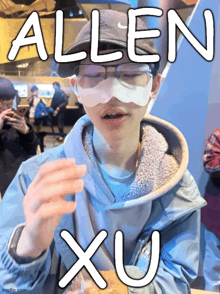a person wearing glasses and a mask with the name allen xu on it