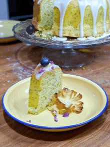 a slice of cake on a yellow plate with a pineapple slice on the side