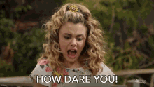 a girl with curly hair is saying how dare you .