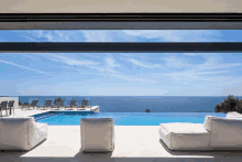 a view of a swimming pool and the ocean from a house