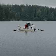 a group of people rowing a boat in a lake with la guarimba film festival written on the bottom of the image