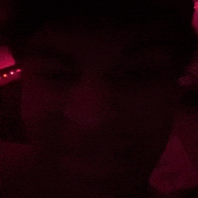 a close up of a person 's face in a dark room