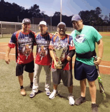 four men are posing for a picture on a baseball field and one of them is wearing a shirt that says the horsemen