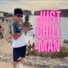 a boy holding a pineapple with the words just chill man on the bottom