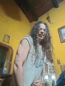 a woman with long curly hair is wearing a shirt with a bicycle on the front