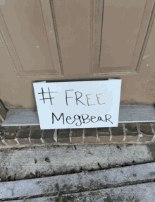 a sign on a door that says #free meg bear