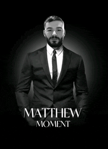 a man in a suit and tie with the name matthew moment