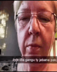 a close up of a woman 's face with glasses and a caption that says żyje dla gangu ty jebana palo .